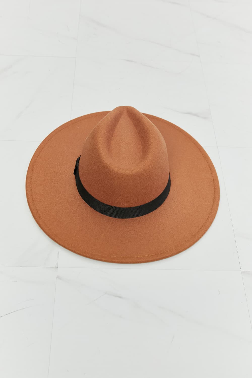 Tan Fame Enjoy The Simple Things fedora hat with black ribbon band on white marble background